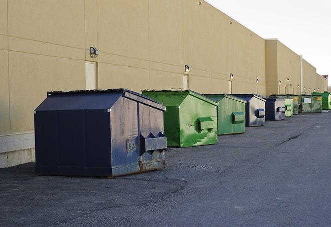 a group of dumpsters lined up along the street ready for use in a large-scale construction project in Fox Lake